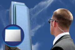 wyoming map icon and security agent watching a downtown area